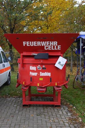Rote Maschine mit der Aufschrift "Feuerwehr Celle" und weiteren Texten auf einem Schild.