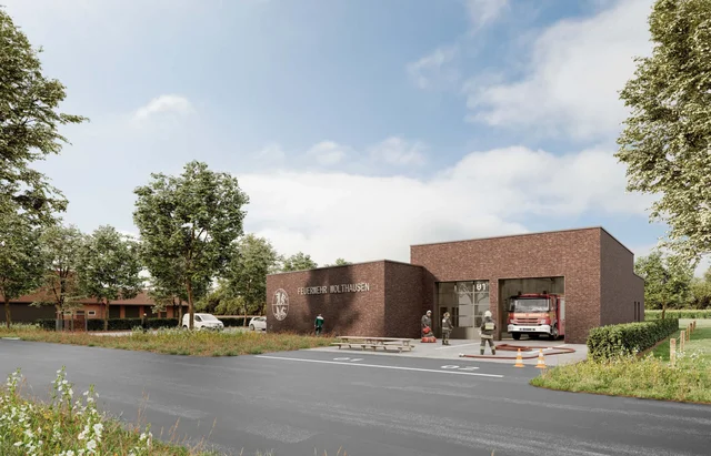 Computergrafik des geplanten Feuerwehrhauses in Wolthausen: eingeschossiges Backsteingebäude mit zwei Toren und dem Schriftzug „Feuerwehr Wolthausen“, in der Halle ein Feuerwehrfahrzeug, davor Einsatzkräfte und eine Straße